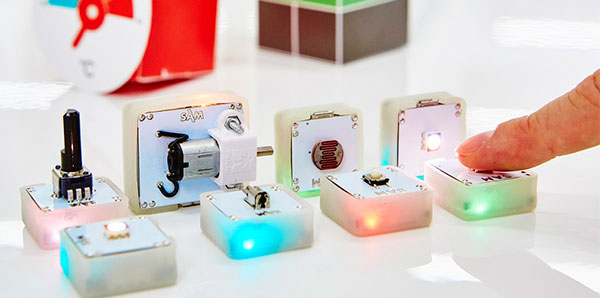 Four Bluetooth-enabled blocks in a line 